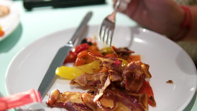 Bacon fork vegetables Person eating breakfast with bacon and vegetables