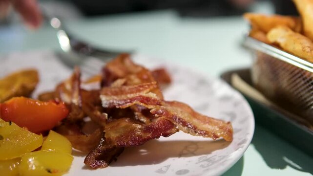 Bacon fork vegetables Person eating breakfast with bacon and vegetables