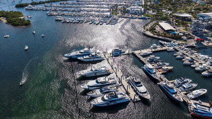 Luxury yachts in marina with sun reflecting on the water 