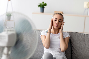 Overheating, fatigue, summer heat and bad feeling. Suffers from headache young blonde woman rest in...