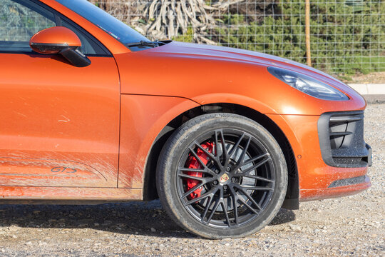 Orange porsche macan gts suv driving off road
