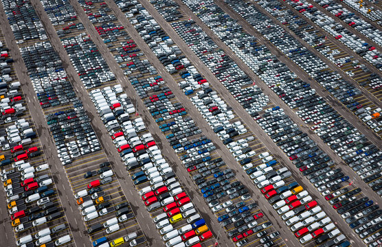 Aerial view of densely parked vehicles at port terminal.