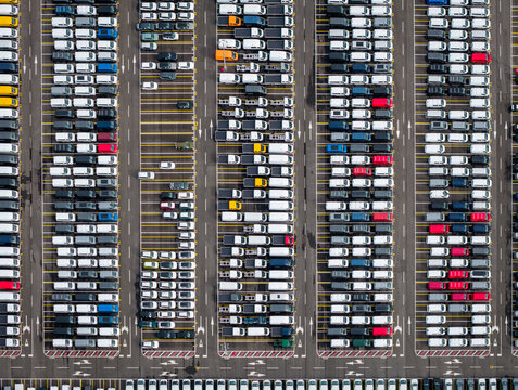 Aerial view of densely parked vehicles at port terminal.