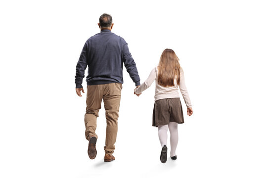 Rear view of a man and a young girl holding hands and walking away