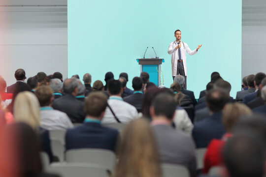 Doctor giving a speech on stage at a medical conference i