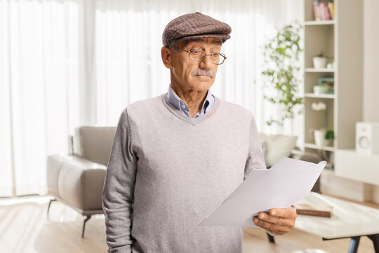Confused senior man reading a document