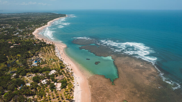 Natural pools in the sea off Taipu de Fora beach, a tourist spot on the Mara&uacute; Peninsula, coast of Bahia, Brazil, panoramic aerial view, coconut trees, blue and green sea, paradisiacal