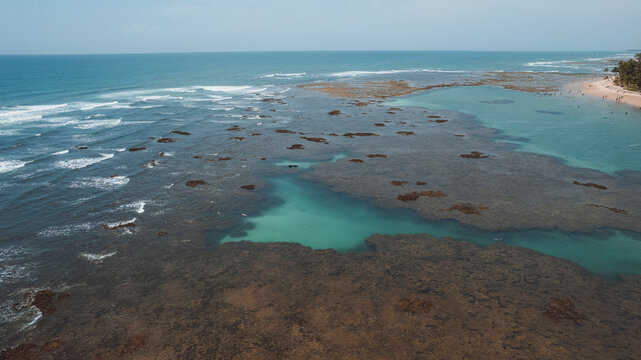 Natural pools in the sea off Taipu de Fora beach, a tourist spot on the Mara&uacute; Peninsula, coast of Bahia, Brazil, panoramic aerial view, coconut trees, blue and green sea, paradisiacal
