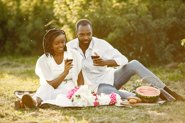 African american couple drinking wine in picnic