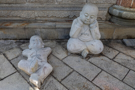 Two Lounging Reclining Happy Buddha Stone Statues in a Temple near Penang, Malaysia