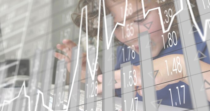 Leaning boy in blue T-shirt typing on laptop in home workspace, with digital charts overlay - Powered by Adobe