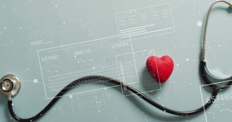 Displaying stethoscope and red heart model lying on matte teal table, with HUD overlays