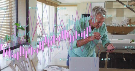Reviewing man in green shirt leaning in home dining area, checking phone with charts, copy space
