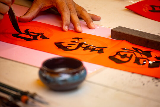 the delicate process of creating Spring Couplets through Chinese calligraphy