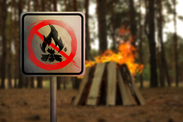 Prohibition sign No Campfires against burning bonfire in forest. Irresponsibility can lead to disaster