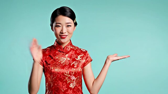 Asian woman in traditional red cheongsam dress pointing left on blue background