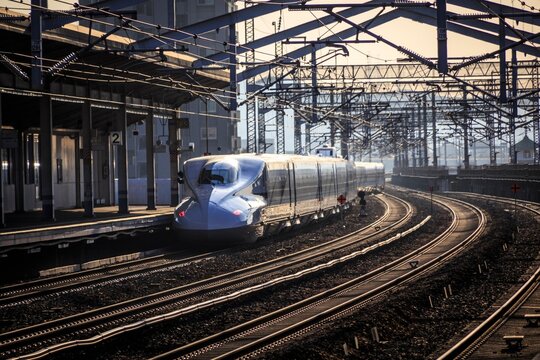 Shinkansen Bullet Train Arriving at a Japanese Station at Dusk