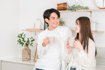 Fototapeta premium Couple drinking coffee in the kitchen at home, couple, new life, newlyweds