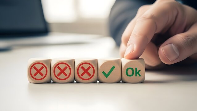 Hand flipping wooden dice from rejection to approval