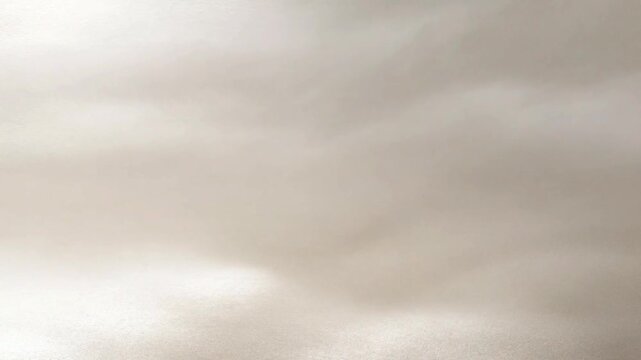 Soft white glitter background with shimmering bokeh effect.