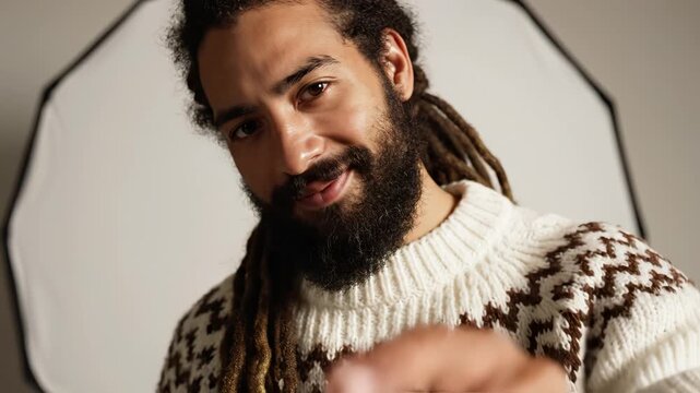 Man with beard pointing at camera