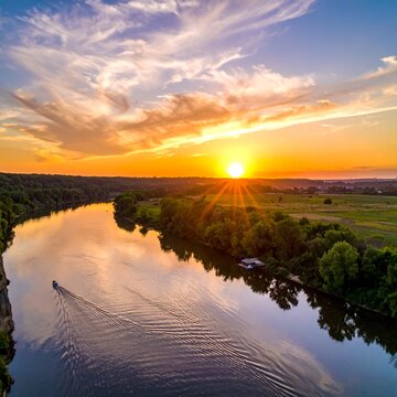 Golden Sunset over River with Boat and Clouds