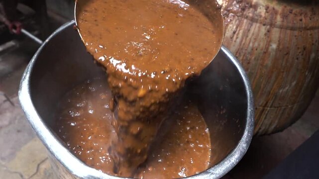 Closeup shot of cooking dal makhni in big utensil.
cooking in Bulk for many people.