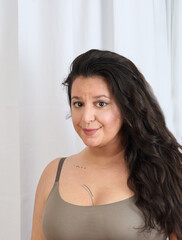 Portrait of a woman in front of a white curtain