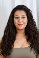 Portrait of a woman in front of a white curtain