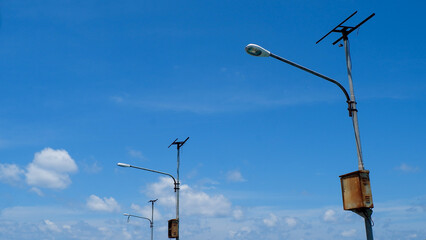 Obraz premium Electric poles and power cables with street lights