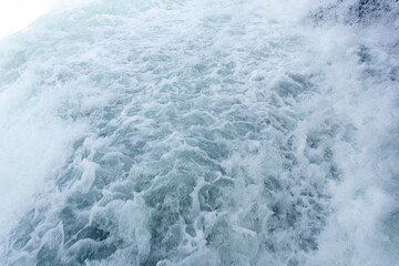A large body of water with a lot of white foam and waves