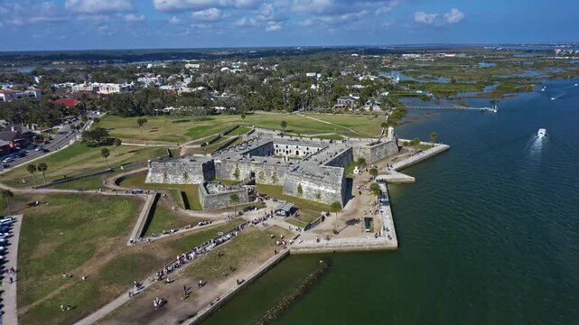 Castillo de San Marcos, the oldest masonry fort in the continental United States, stands prominently on the Matanzas River waterfront in St Augustine Florida, surrounded by parkland and urban areas.