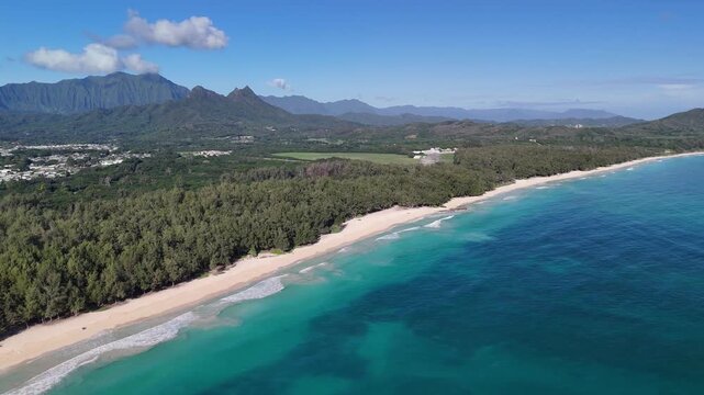 4k drone footage of beautiful clear blue ocean on waimanalo beach showing Olomana mountain and the Koolaus on Oahu Hawaii
