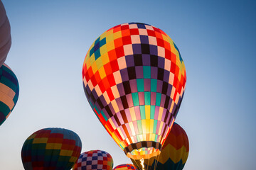 colorful hot air balloons glowing against sky