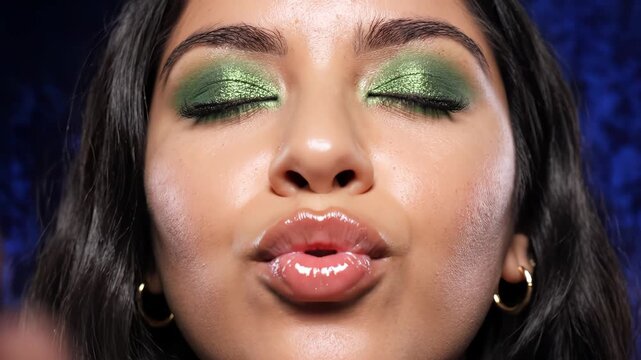 Closeup of woman with green eye makeup