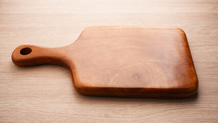 Wooden Chopping Board or Talenan on textured surface