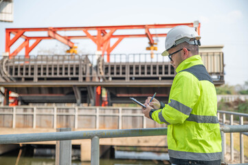 A specialist inspector is checking the water diversion system of the wastewater treatment plant.