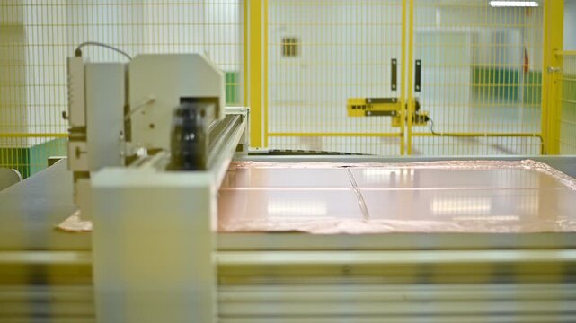 A close-up view of a high-precision machine working in a modern industrial setting, showcasing advanced technology and manufacturing processes.