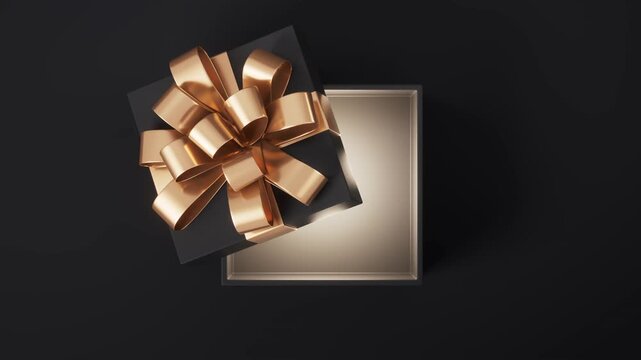 Black gift box with gold ribbon opens slowly revealing glowing empty interior