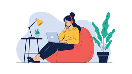 Young woman wearing red headphones sitting comfortably in a bean bag chair while working on a laptop in a relaxed home office.