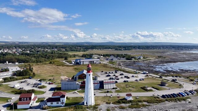 Aerial view of Pointe au Pere lighthouse near Rimouski on rocky coastline, Quebec, Canada, summer daylight. g.