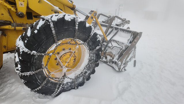 Heavy equipment clears snow in winter storm