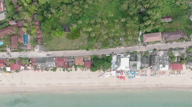 Tropical Beachfront Village Aerial Koh Lanta Thailand, Top down panning houses rooftops beach coastal village