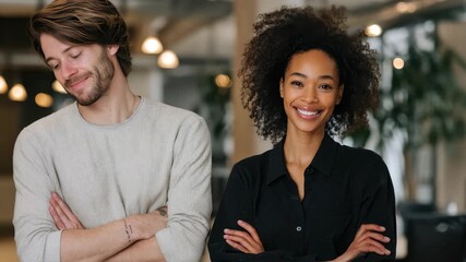 Two colleagues from diverse backgrounds share a moment in a modern office environment during a casual business day, showcasing professional camaraderie and collaboration