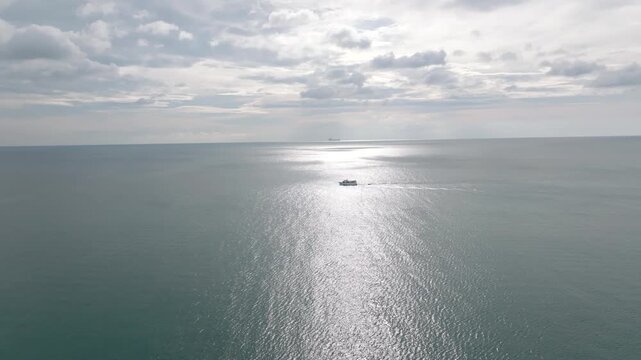 Aerial fly reflected lonely boat sailing at the sea of Lanta Klong Nin, Koh Lanta, Thailand