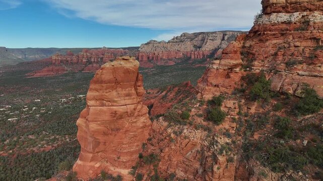4K epic drone video passing through Sedona arizona red rock mountain peaks with stunning mountains and folliage in background