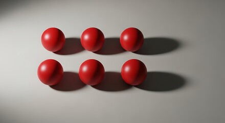 Six Red Spheres Arranged in Two Rows on a Luminous White Surface with Dramatic Shadows and Highlights