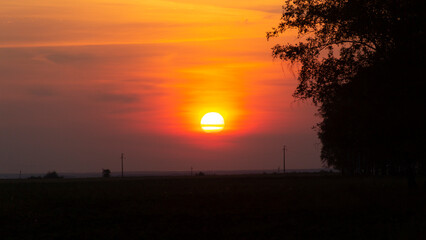 Sunset against a backdrop of clouds close to the horizon on planet Earth