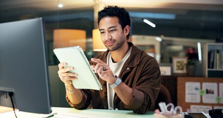 Fototapeta premium Online, reading and man with tablet, office and research for campaign and working late with project. Digital marketing, social media manager and person with tech for deadline and creative at night