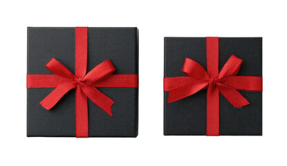 Overhead shot of two black gift boxes tied with bright red ribbon bows against a black backdrop